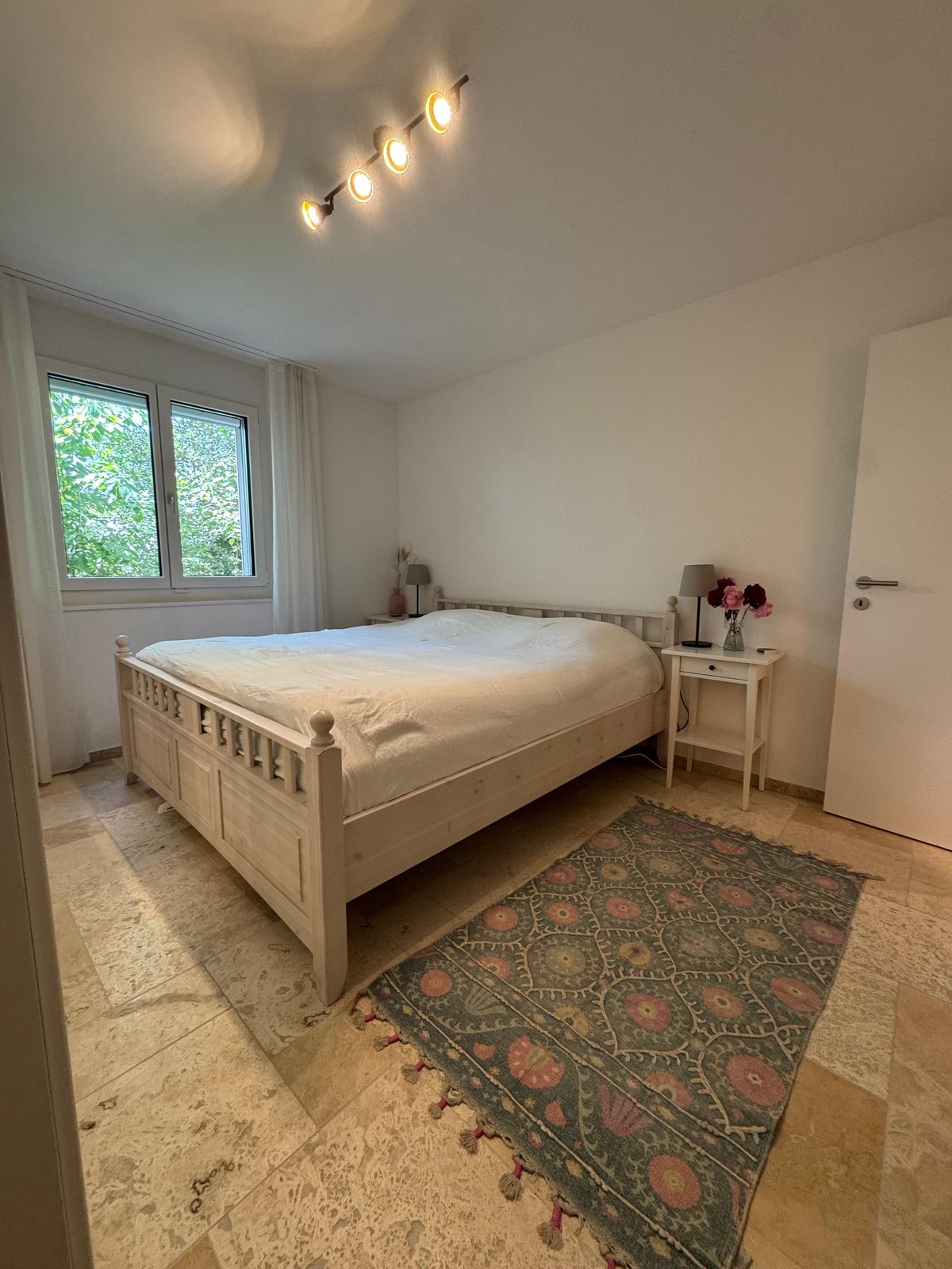 Second bedroom with solid-wood bed in corporate housing near Baden, lower floor