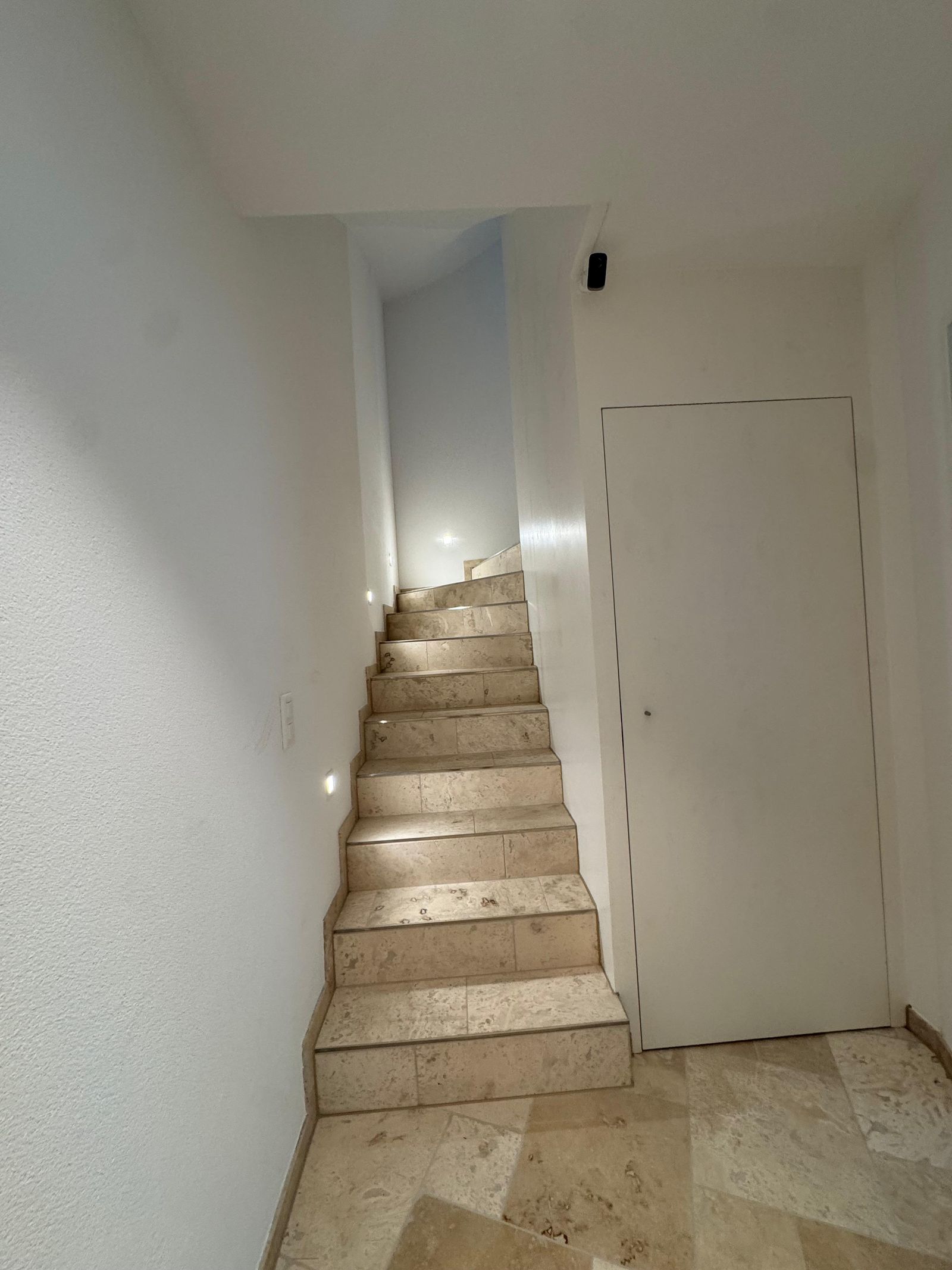 Hallway of Villa 77, finished in travertine throughout