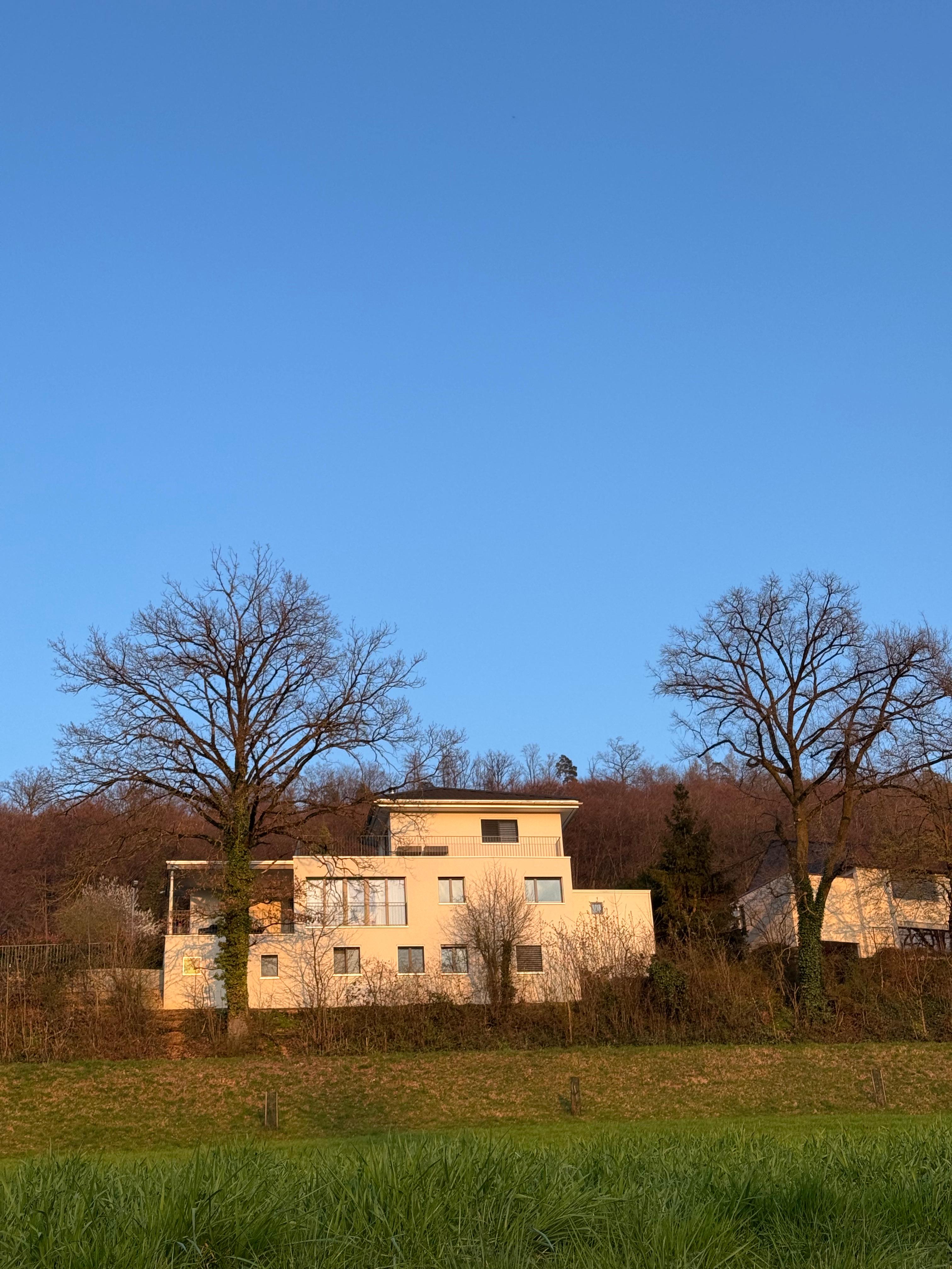 Villa 77 in evening light, set on the hillside above Unterendingen, Aargau